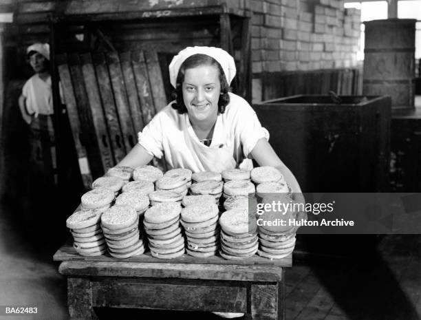 Some of the 100,000 crumpets made every day at Cadby Hall by Lyons during the 'season' which lasts from the beginning of October to Good Friday of...