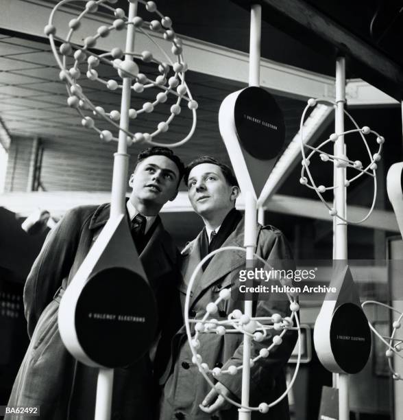 Two boys studying models of electron orbits in the Dome of Discovery at the Festival of Britain, 1951.