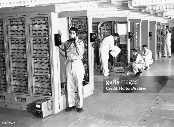 Technicians of the U.S. Army are briefed on the electronic equipment used in the Signal Corps Missile Master installation, 1950s