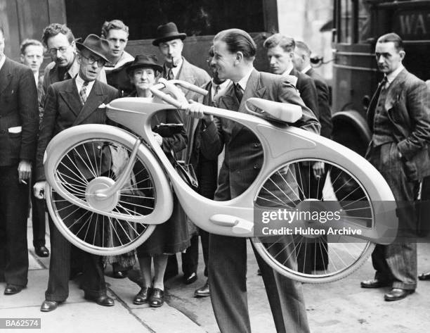 Mr B G Bowden shows off the state of the art bicycle he has designed for the 'Designs of the Future' section of the upcoming 'Britain Can Make it'...