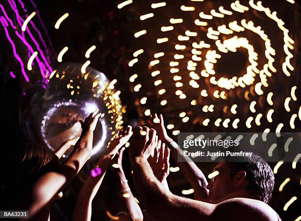 group of people dancing, arms raised, close-up (long exposure) - justin stock pictures, royalty-free photos & images