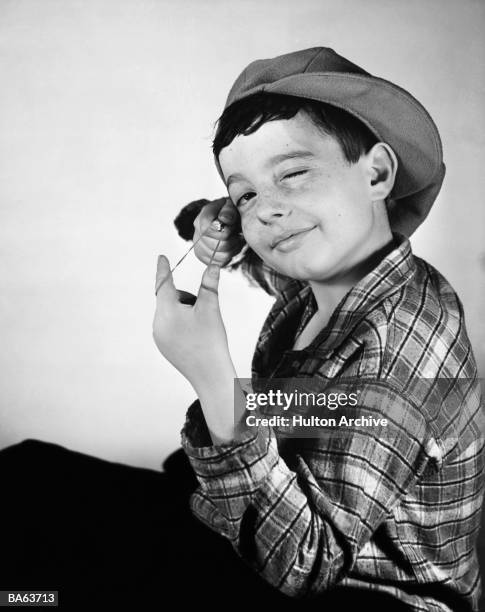 Boy about to release elastic band catapult, portrait