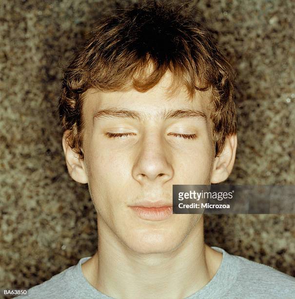 teenage boy (15-17), eyes closed, portrait, close-up - microzoa stock pictures, royalty-free photos & images