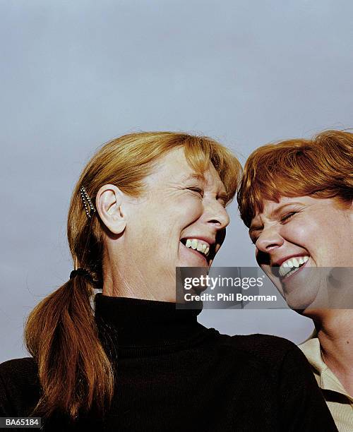 mature woman and adult daughter laughing, outdoors, close-up - phil stock pictures, royalty-free photos & images