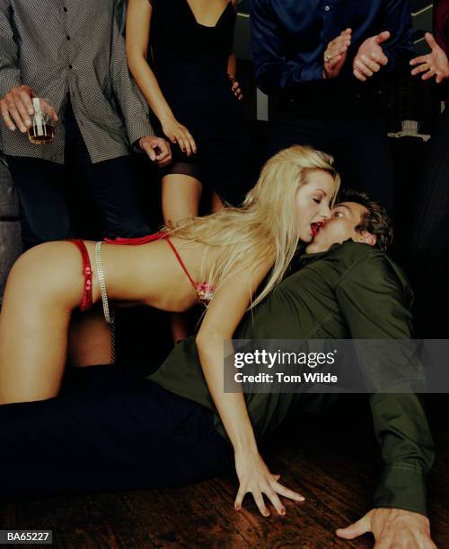 female stripper crawling on top of mature man on bar floor - individu étrange photos et images de collection