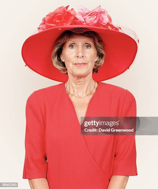 mature woman wearing floral hat, portrait - ascot hut stock-fotos und bilder