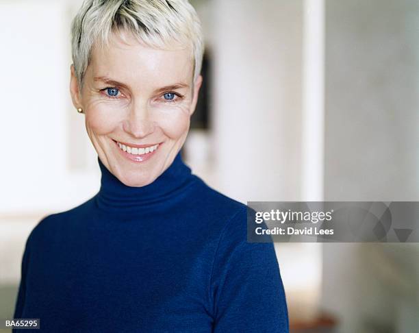 mature woman wearing blue polo neck, portrait, close-up - polo neck stock-fotos und bilder