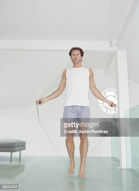 man skipping at home - mid adult men stock pictures, royalty-free photos & images