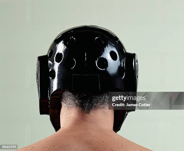 man wearing head protector, rear view - head protector stock pictures, royalty-free photos & images