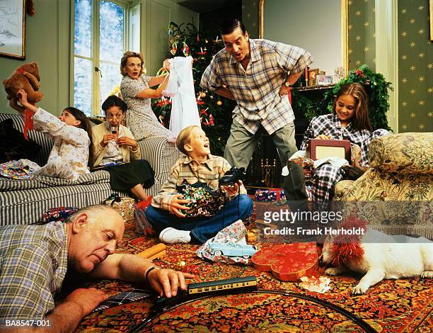 christmas day in living room,family and dog unwrapping & enjoying gift - open day 9 bildbanksfoton och bilder