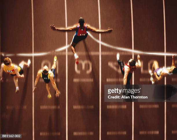 athletics, runners at finish line, overhead view (digital composite) - winning stock-fotos und bilder