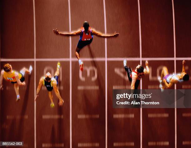 athletes in race crossing finishing line, overhead view (composite) - leichtathletikstadion stock-fotos und bilder