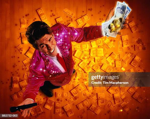 gameshow host surrounded by cash, overhead view (digital composite) - television host stock-fotos und bilder