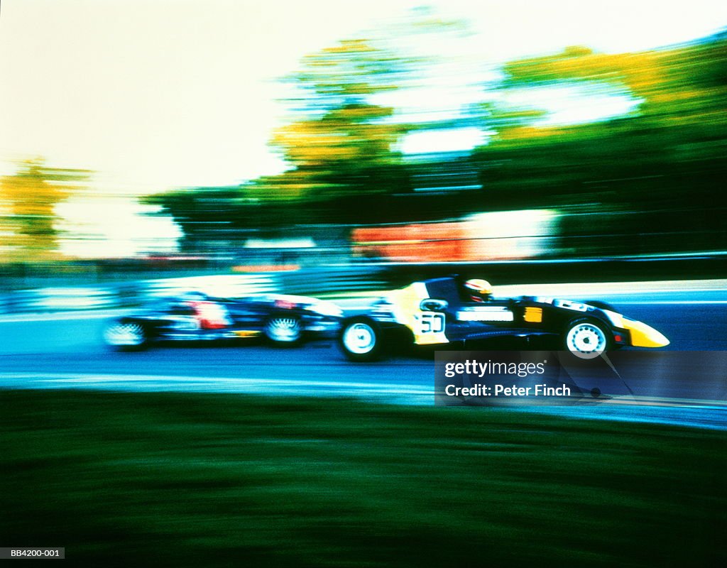 Two Formula Ford ZETEC racing cars on track (cross-processed)