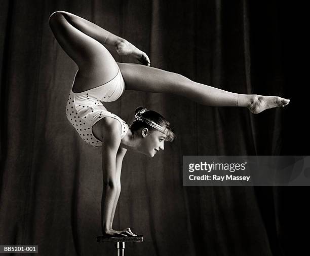 female contortionist balancing on hands (b&w) - artist stock-fotos und bilder