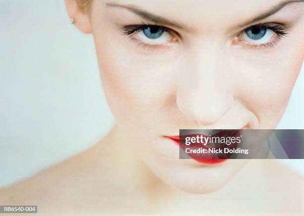 young woman biting lip, close-up - morder imagens e fotografias de stock