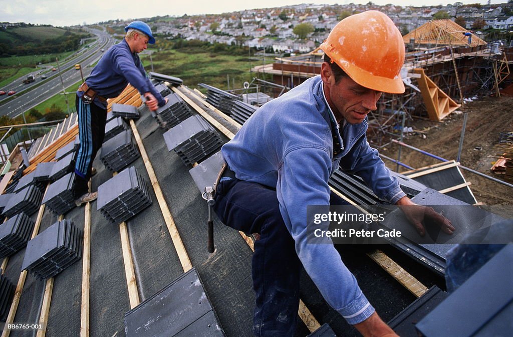 Roofer at work on new house, close-up