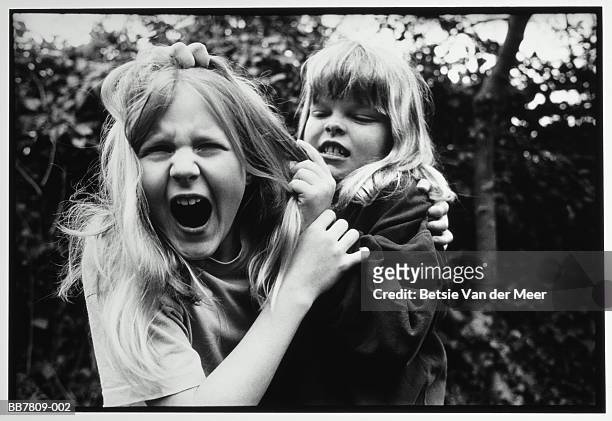two girls (9-11) fighting outdoors (b&w) - children fighting stock pictures, royalty-free photos & images