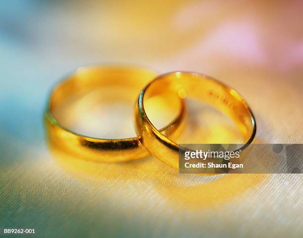 two gold wedding bands, close-up - married stock pictures, royalty-free photos & images