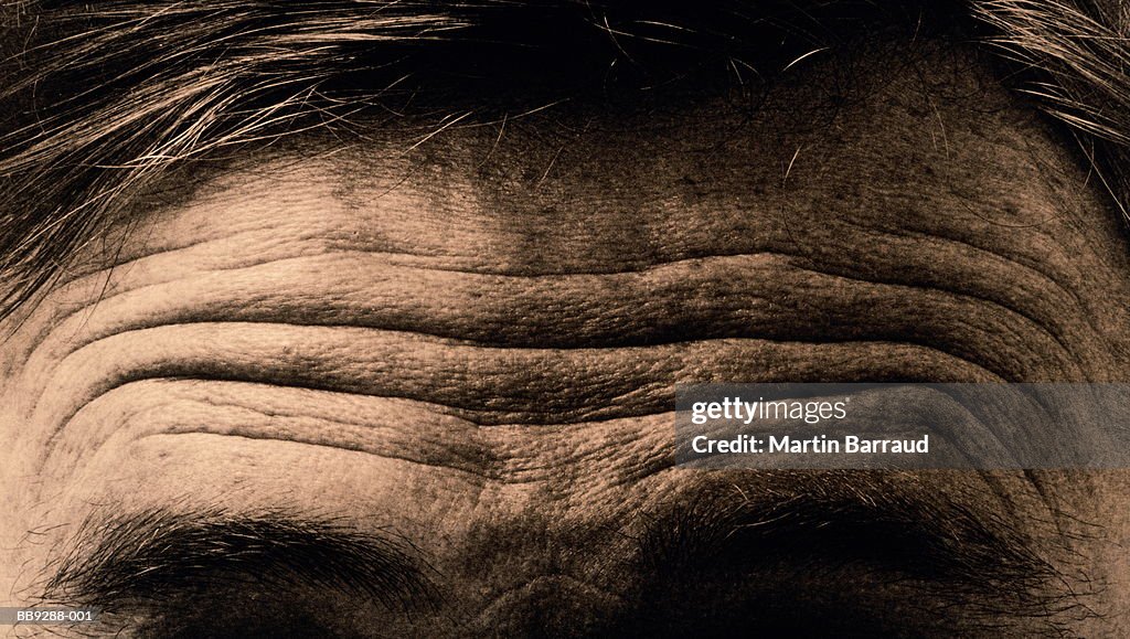 Frowning male forehead, close-up (toned B&W)