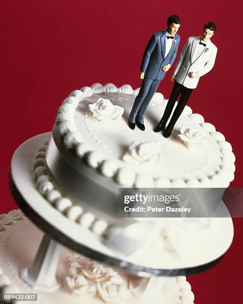 wedding cake with two groom decorations, pink background - cake tier stock pictures, royalty-free photos & images
