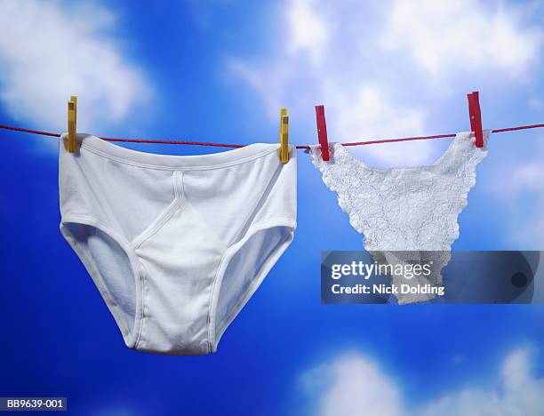 pair of underpants and pair of knickers on washing line - slip stock-fotos und bilder