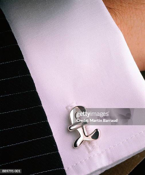 cuff of businessman's shirt with cuff-link shaped as pound sign - cuff link stock pictures, royalty-free photos & images