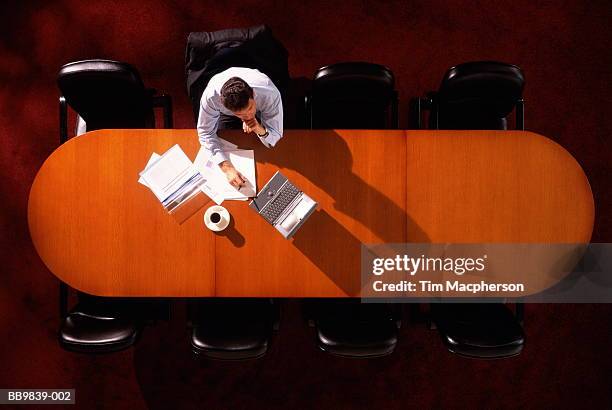 executive sitting at boardroom table, overhead view - only men boardroom stock pictures, royalty-free photos & images