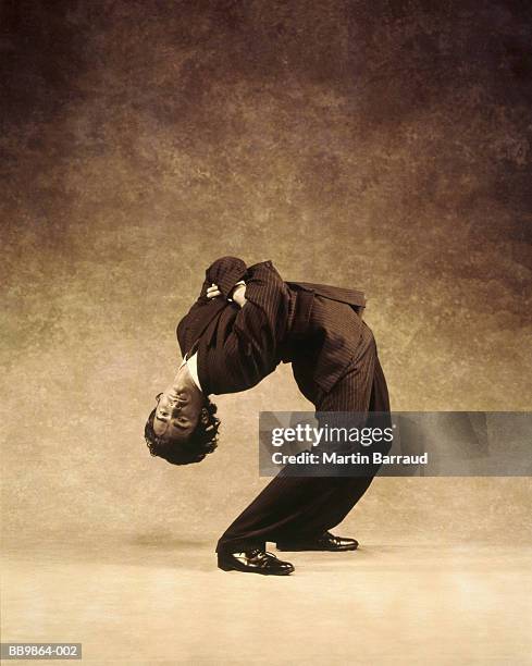 businessman bending over backwards (toned b&w) - double jointed stock pictures, royalty-free photos & images