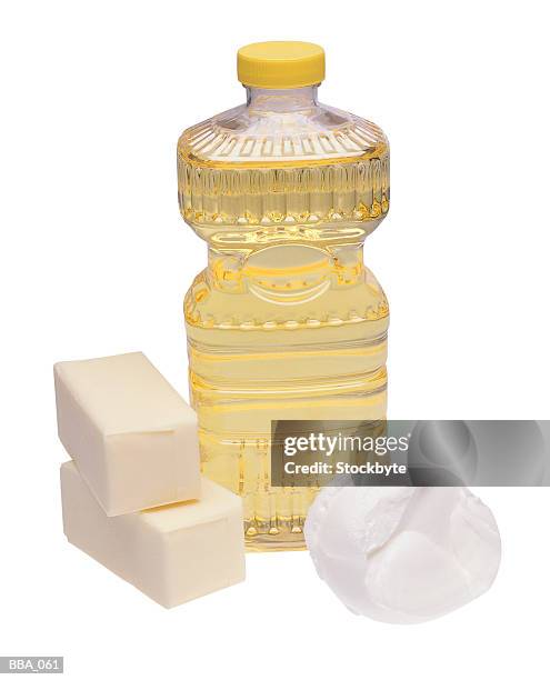 bottle of oil, two bricks of butter and scoop of shortening - corn oil foto e immagini stock