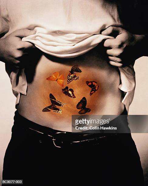 young man with butterflies in stomach (digital composite) - animal abdomen fotografías e imágenes de stock