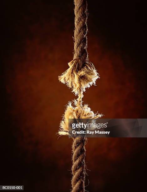length of frayed rope, holding together by a single thread - rope length stock pictures, royalty-free photos & images