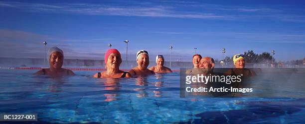 group of elderly men and women in outdoor swimming-pool - anti ageing stockfoto's en -beelden