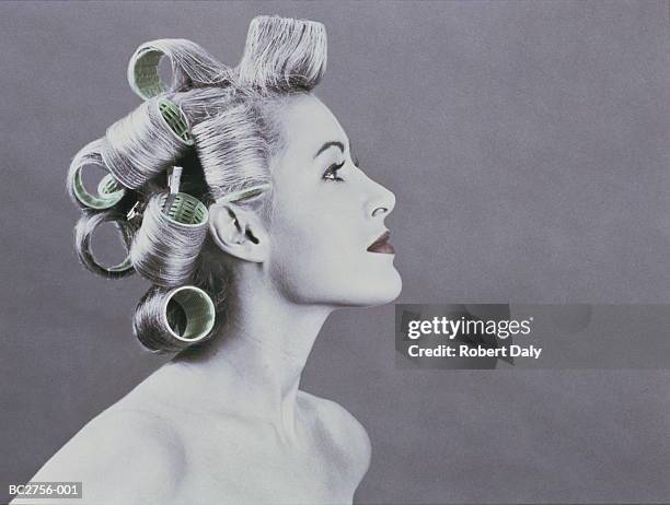 naked young woman wearing curlers in her hair, profile (tinted b&w) - hair curlers stock pictures, royalty-free photos & images