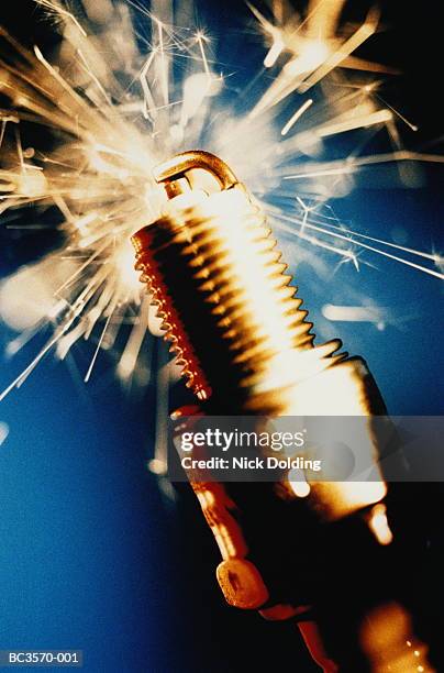 spark plug surrounded by sparks, close-up - spark plug stock pictures, royalty-free photos & images