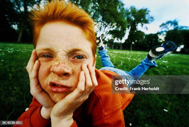 boy (7-9 years) lying on grass, portrait (digital enhancement) - 6 7 years stock-fotos und bilder