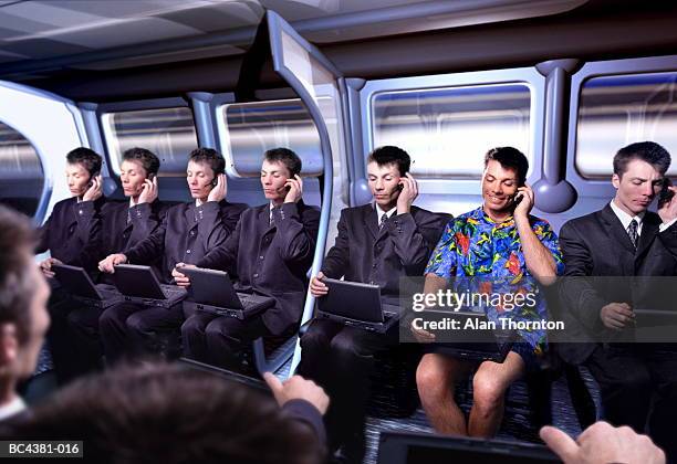 executive in hawaiian shirt amongst commuters (digital composite) - individuality foto e immagini stock