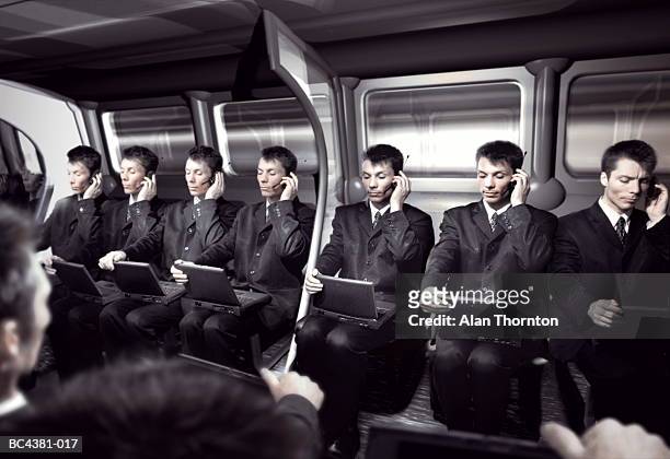 cloned executives in train carriage (digital composite) - cloning stock-fotos und bilder