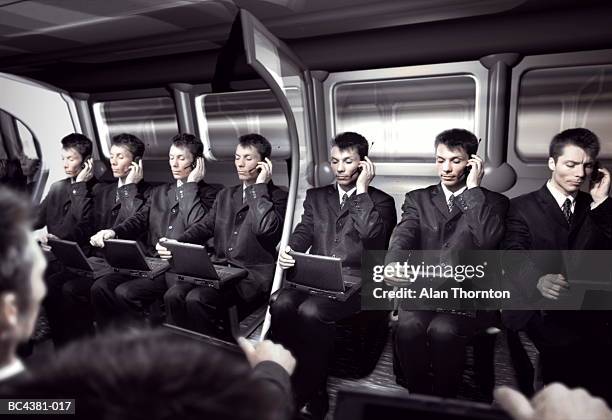 cloned executives in train carriage (digital composite) - cloning device stock pictures, royalty-free photos & images