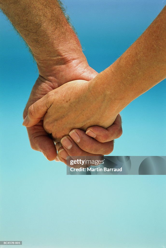 Couple holding hands, close-up