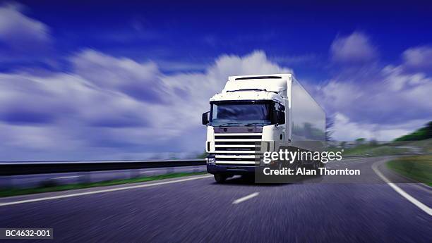 lorry driving on motorway (digital enhancement) - camion fotografías e imágenes de stock