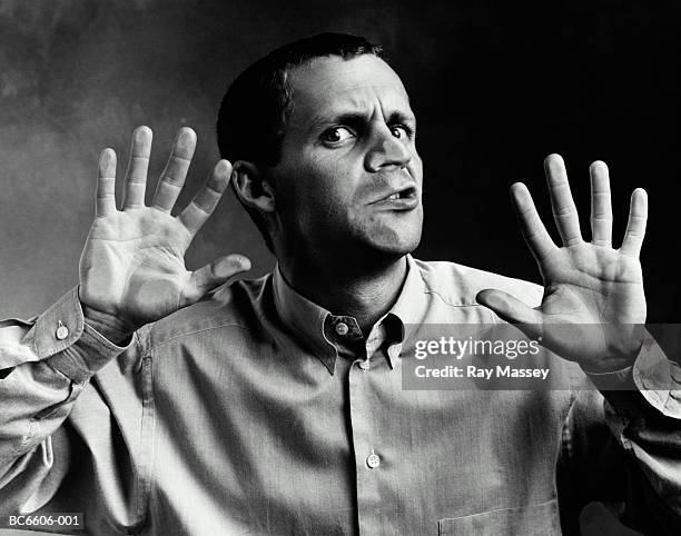 man with face pressed up against window (b&w) - hands behind glass stock pictures, royalty-free photos & images