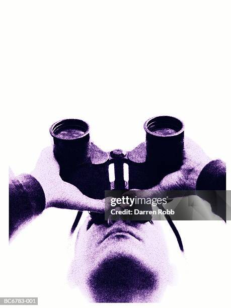 man looking through binoculars, low angle view, close-up (toned b&w) - binocular with man stock pictures, royalty-free photos & images