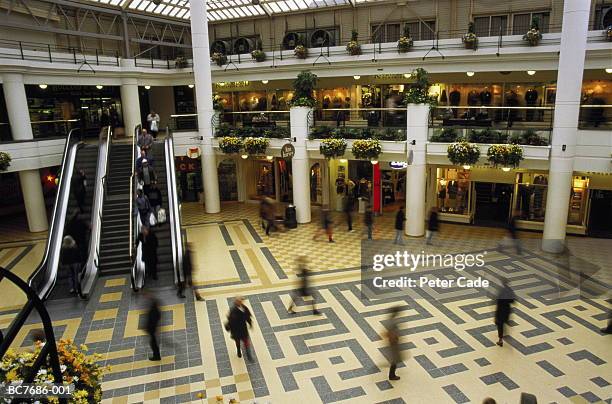 indoor shopping centre concourse, england, elevated (long exposure) - interior shop stock pictures, royalty-free photos & images
