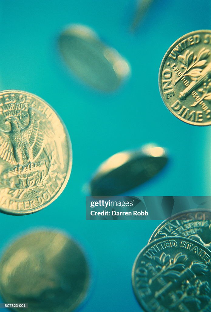 American currency: assorted coins, green background