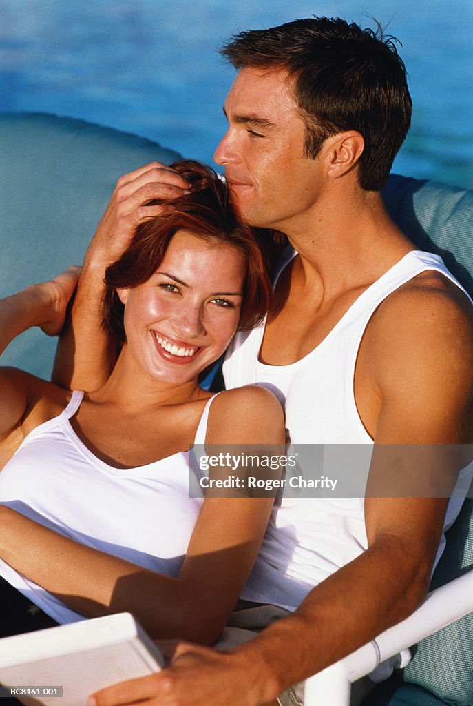 Young couple on holiday embracing, close-up