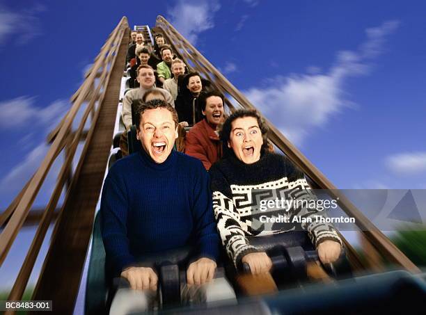 people on rollercoaster ride, screaming (digital enhancement) - young woman screaming on a rollercoaster stock-fotos und bilder