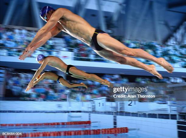 three male swimmers diving off starting blocks (digital composite) - young men in speedos stock pictures, royalty-free photos & images