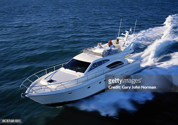 group of people relaxing on power boat, elevated view - motorboat foto e immagini stock