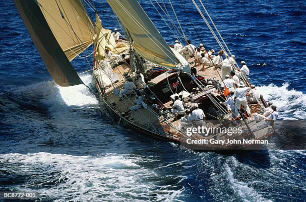 yacht at sea, crew on deck, rear view - yacht club stock pictures, royalty-free photos & images